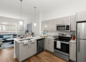 Thumbnail 8 of 10 - A modern kitchen with stainless steel appliances and wooden cabinets.