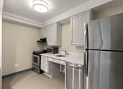 Thumbnail 24 of 29 - A kitchen with a stainless steel refrigerator, microwave, oven, and sink. at AVIA Lofts on Parkway, Washington , 98662