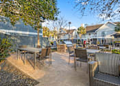 Thumbnail 46 of 47 - a patio with tables and chairs and a fence