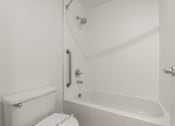 Thumbnail 21 of 29 - A white toilet sits next to a white bathtub in a bathroom. at AVIA Lofts on Parkway, Vancouver