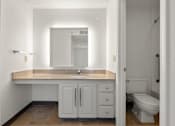Thumbnail 23 of 29 - A bathroom with a sink, toilet, and mirror. at AVIA Lofts on Parkway, Washington