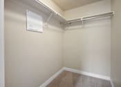 Thumbnail 13 of 17 - A white metal shelf is mounted on a wall.