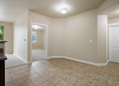 Thumbnail 5 of 17 - A room with a tiled floor and white walls.