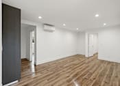 Thumbnail 23 of 39 - Large Bedroom with Wall Heater, Cabinet Storage, and Window Shades