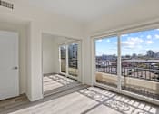 Thumbnail 24 of 48 - Bedroom with Mirrored Closet, Private Balcony, and Vinyl Flooring
