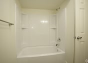 Thumbnail 5 of 36 - White tub/shower with built in shelves