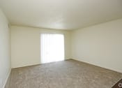 Thumbnail 8 of 36 - Large carpeted living room with sliding patio door and blinds