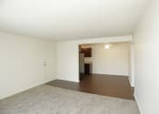 Thumbnail 9 of 36 - View of front door from carpeted living room and wood panel dining area