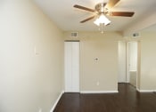 Thumbnail 15 of 36 - Large dark wood panel flooring and utility closet with ceiling fan