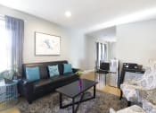 Thumbnail 2 of 36 - large living room with modern wood panel flooring and black sofa with paisley arm chairs