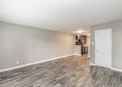 Thumbnail 11 of 31 - Kitchen with dark cabinets and granite-style countertops at Chapel Creek Apartments Dallas