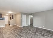Thumbnail 10 of 31 - Open-concept living room with wood-style flooring at Chapel Creek Apartments Dallas