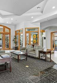 A spacious lobby with a coffee table and couches.