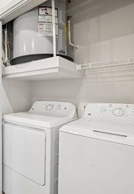 A small laundry room with a washer and dryer.