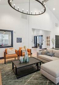 A modern living room with a grey sofa and a black coffee table.