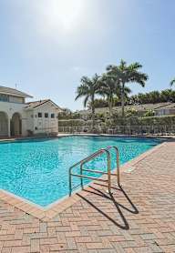 a large swimming pool in front of a house