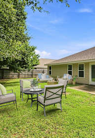 A backyard with a patio table set for four.