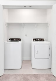 a washer and dryer in a white laundry room