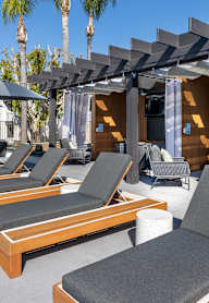 A patio with wooden furniture at Verandas Apartments, West Covina, 91791