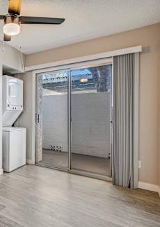 A room with a ceiling fan and a window with a view of the outside. at Tides on East Cactus Apartments, Phoenix, Arizona