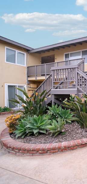 A courtyard with a staircase and a small garden.