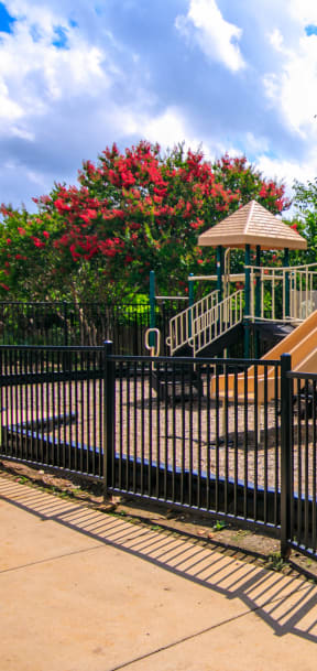 a playground with a slide at a park