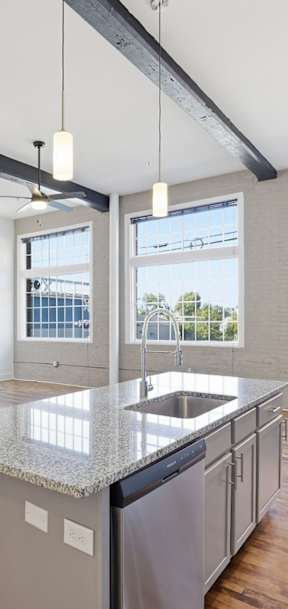 A kitchen with a large island and a view of the city.
