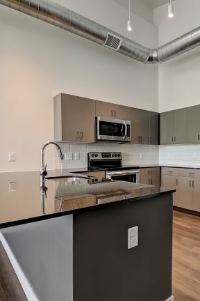 a kitchen with an island and stainless steel appliances
