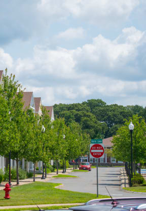 a row of houses on a street with a do not enter sign