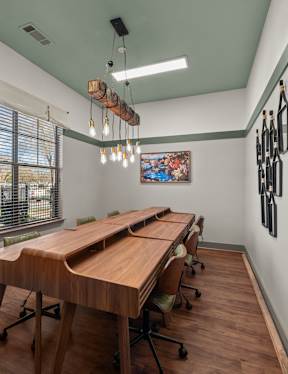 A conference room with a long table and chairs.