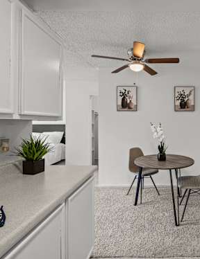 A small kitchen with a table and chairs.