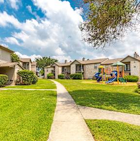 A sunny day at a residential area with houses and a playground.
