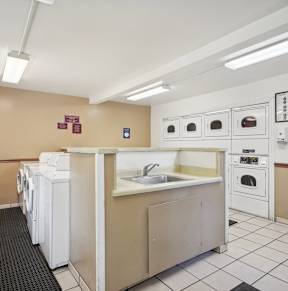 a kitchen with a sink and washes and dryers in it