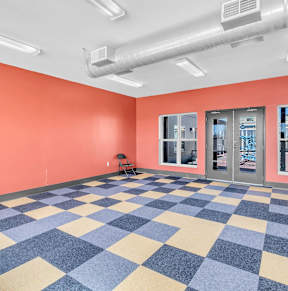 A room with orange walls and a checkered floor.