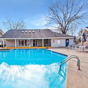 A swimming pool with a building behind it.