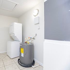 a laundry room with a washer and dryer and a washing machine and refrigerator