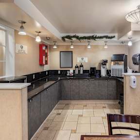 A kitchen with a counter and a chair.