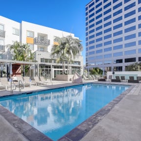 a swimming pool in front of a tall building