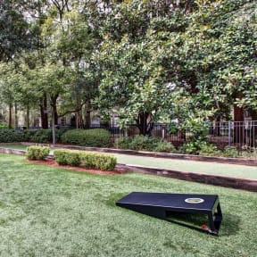 a backyard with a ping pong table and a bench