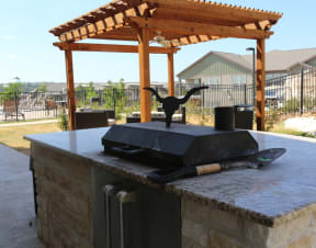 an outdoor fireplace with an awning over it