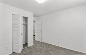 an empty kitchen with white cabinets and stainless steel appliances