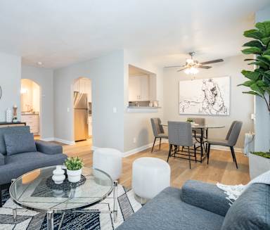 a living room with a couch and a glass coffee table