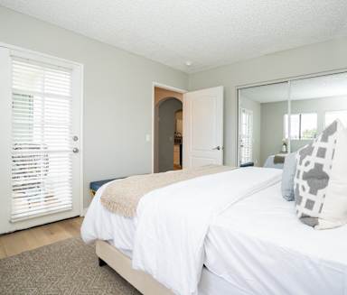a bedroom with a bed and a door to a bathroom