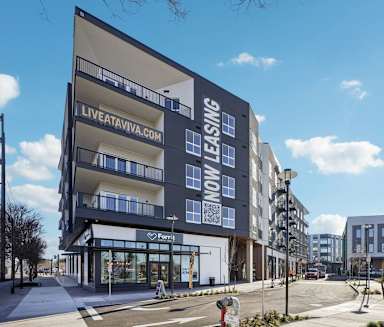 A modern building with the words "Live at Viva" on the side.
