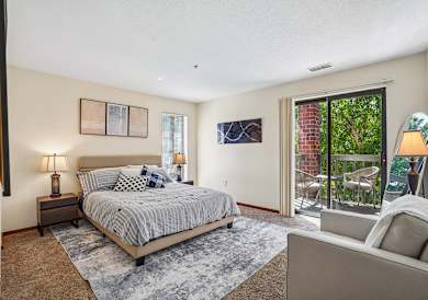 A bedroom with a large bed and a couch.