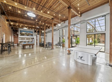 an open room with a ping pong table in the middle