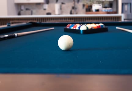 A pool table with a variety of pool balls. at Allure Apartments LLC Apartments, Indiana