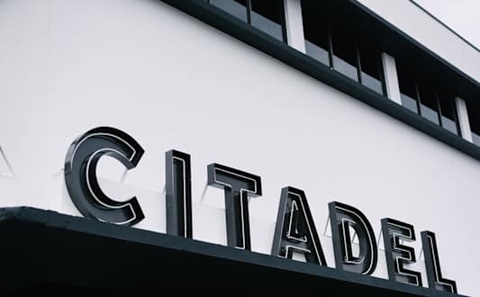 A modern building with a black facade and the words "OFF SITE" written on it.