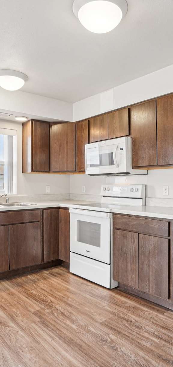 A kitchen with a table and chairs in front of a wall with pictures of space on it.
