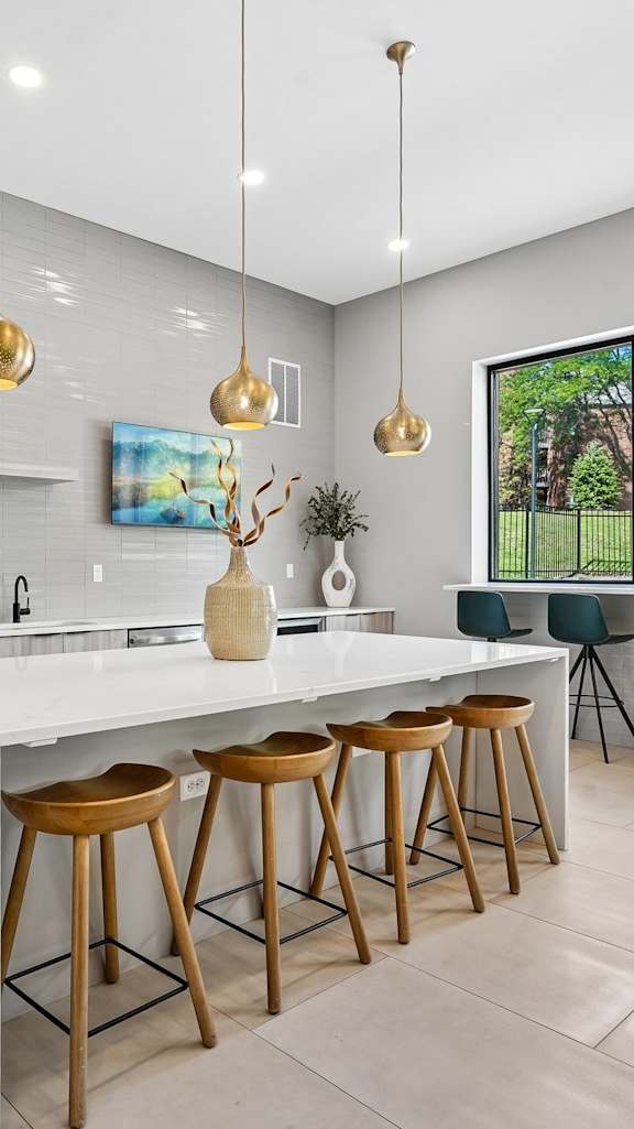 A kitchen with a sink and a refrigerator.